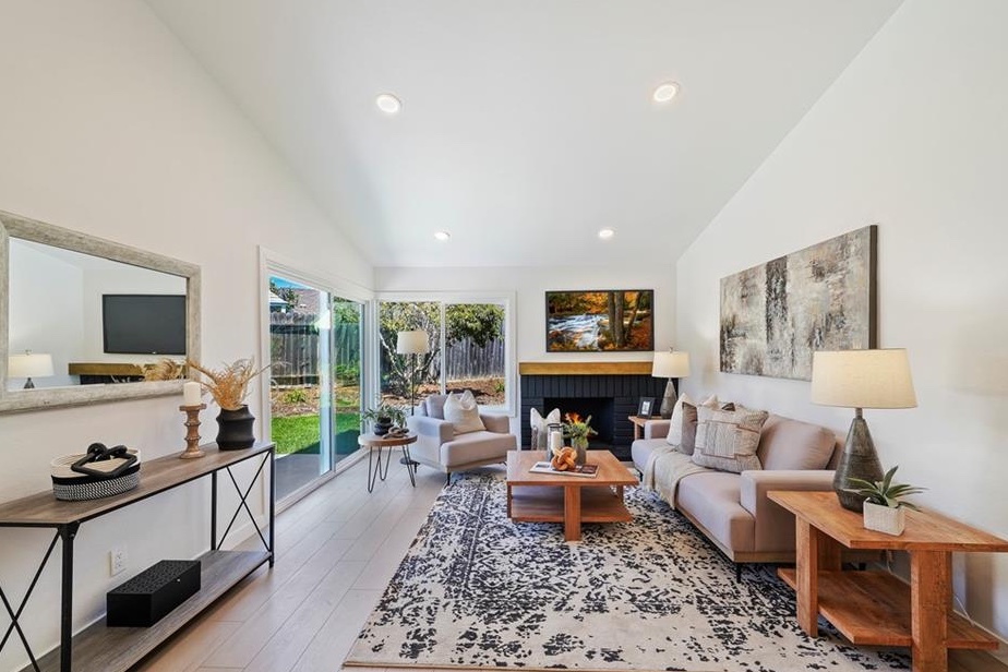 Living room with a vaulted ceiling and fireplace in a recently completed TJB Construction renovation
